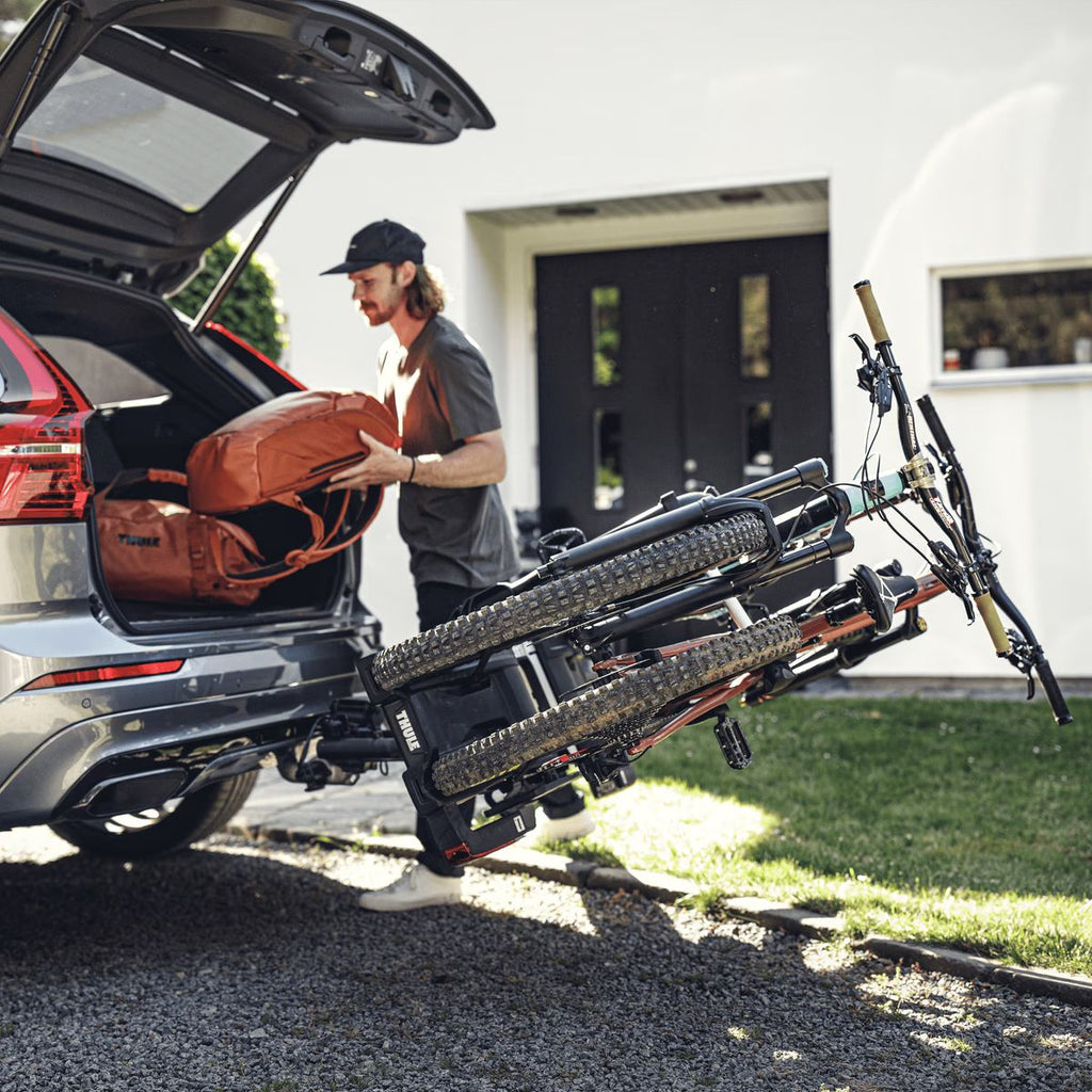 Thule EasyFold XT 2 Bike Car Bike Rack - Tow Ball mount lifestyle image of rack mounted and tilted with bikes attached